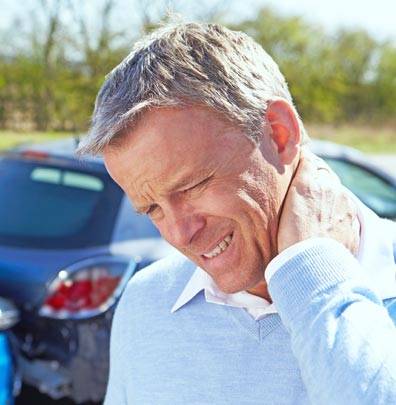 Man holding back of neck in pain